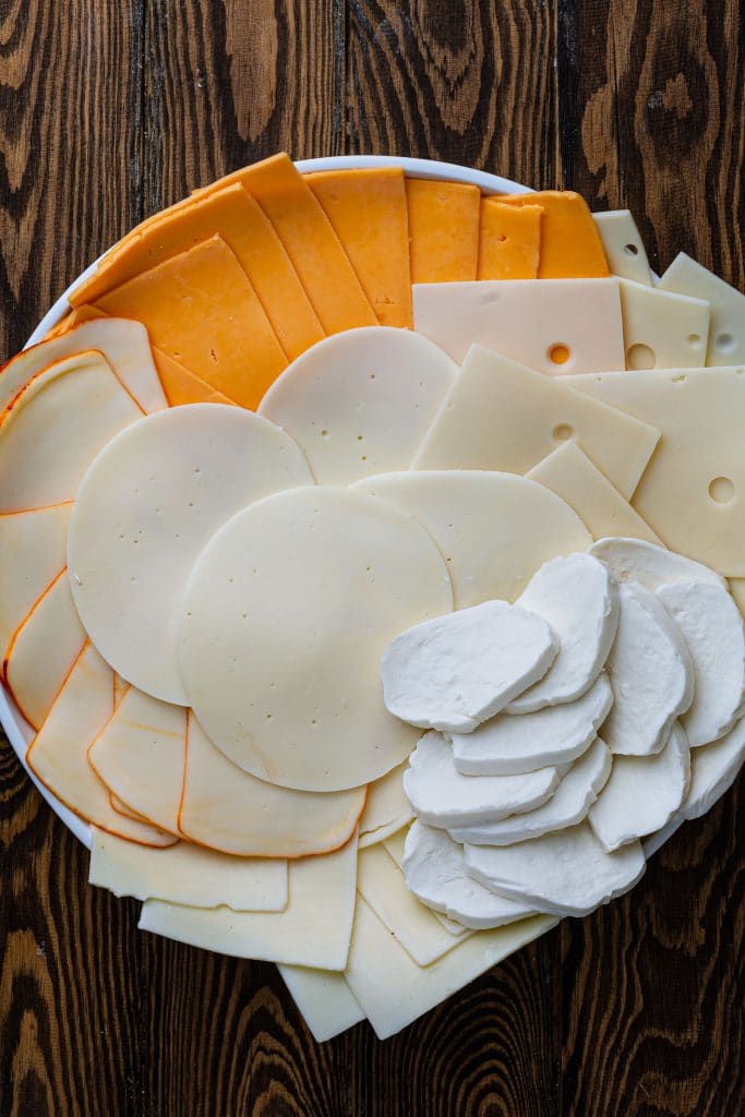 A platter with different kinds of cheese.