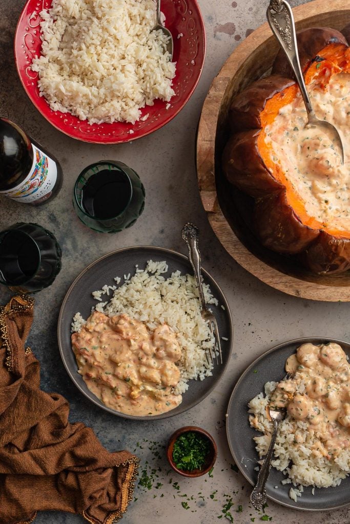 A serving scene: two individual servings of Brazilian shrimp stew with rice.