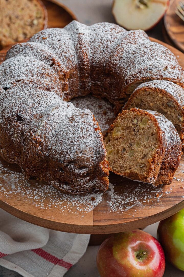 An apple bundt cake on a cake stand.