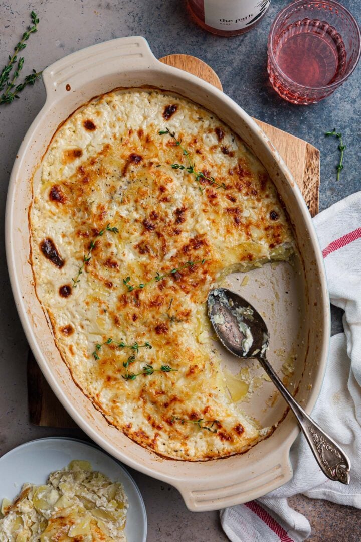 An overhead shot of a gratin dish with Potato Gratin Dauphinois, missing 1/4 of it.