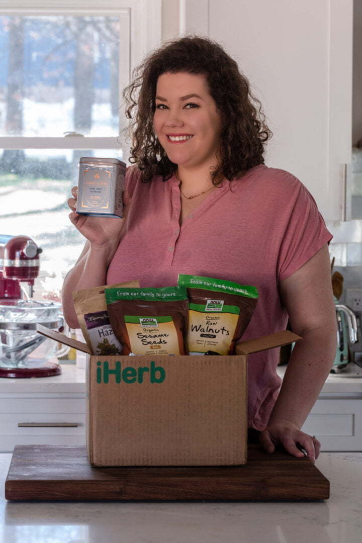 Olivia from Olivia's Cuisine opening a box from iHerb.