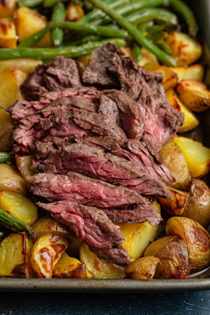 Sheet pan skirt steak over potatoes and green beans.