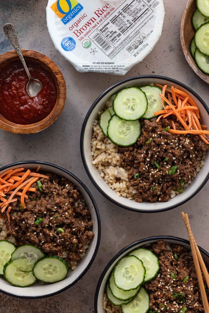 3 Korean Beef Bowls, served with Gochujang sauce.