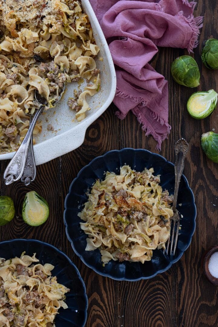 A photo of a serving scene. The casserole and two plates.