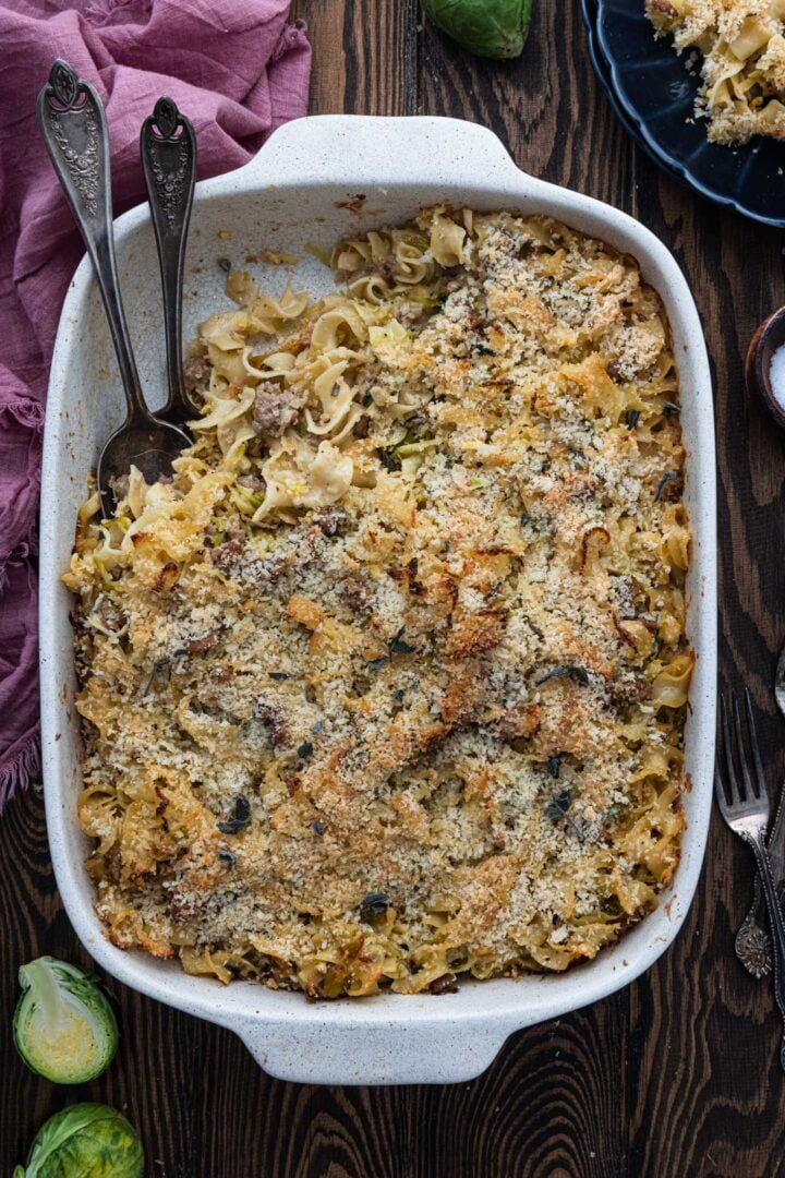 A baking dish with sausage and Brussels sprouts casserole.