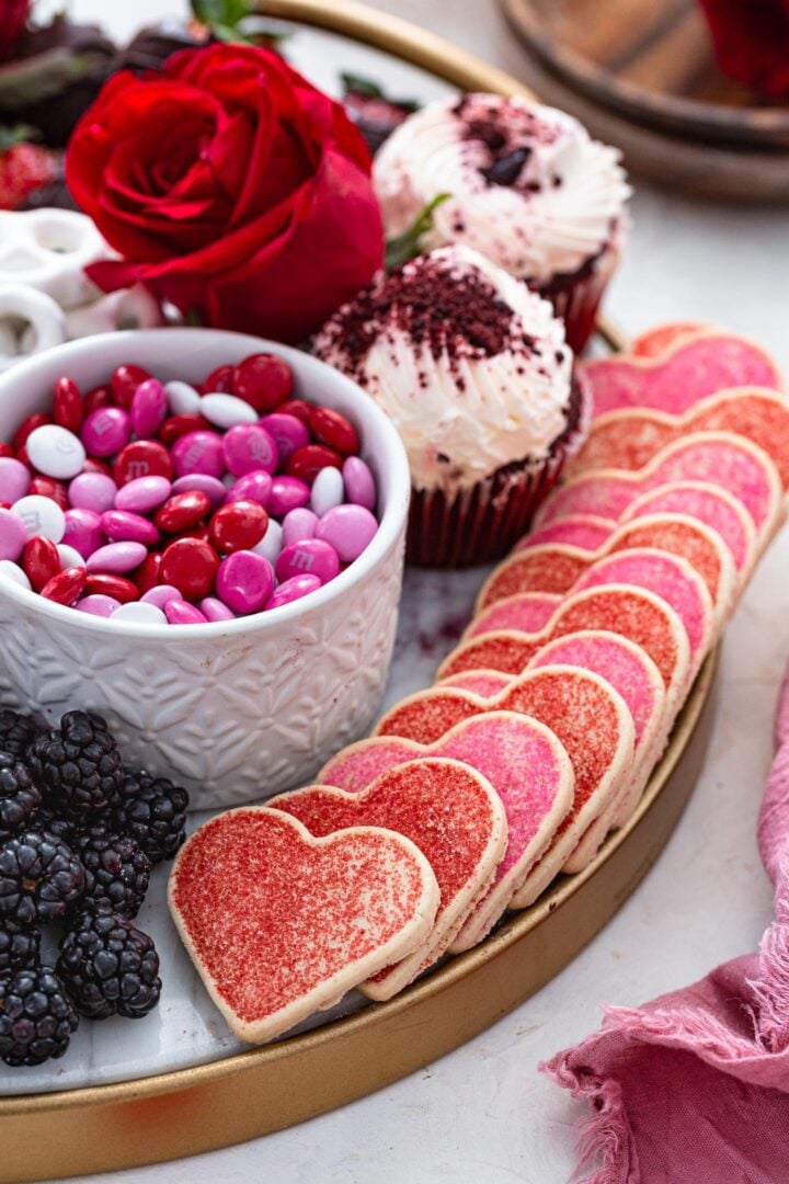 Heart shaped cookies on a dessert board.