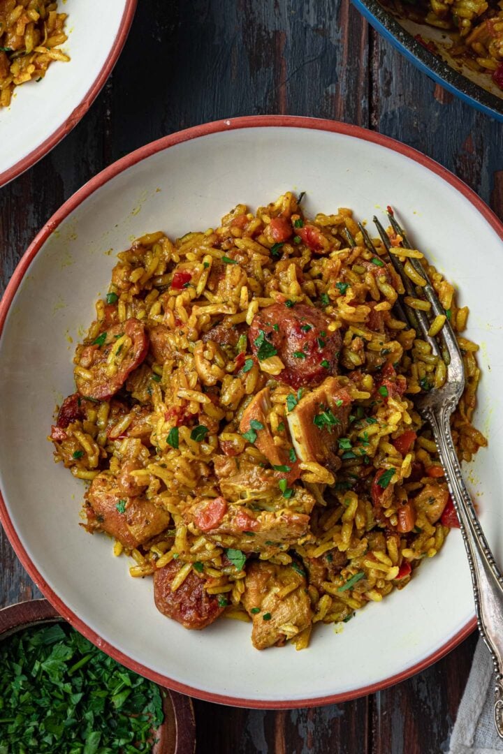 An overhead image of a plate of Brazilian chicken and rice (Galinhada).