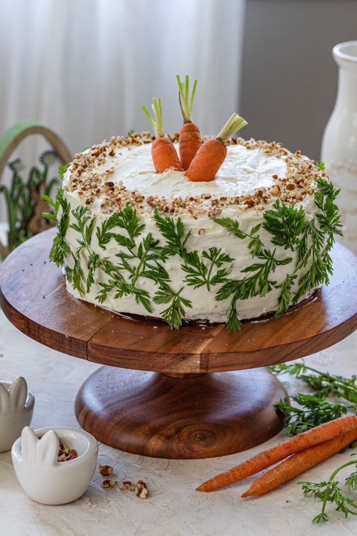 An Easter carrot cake on a cake stand.