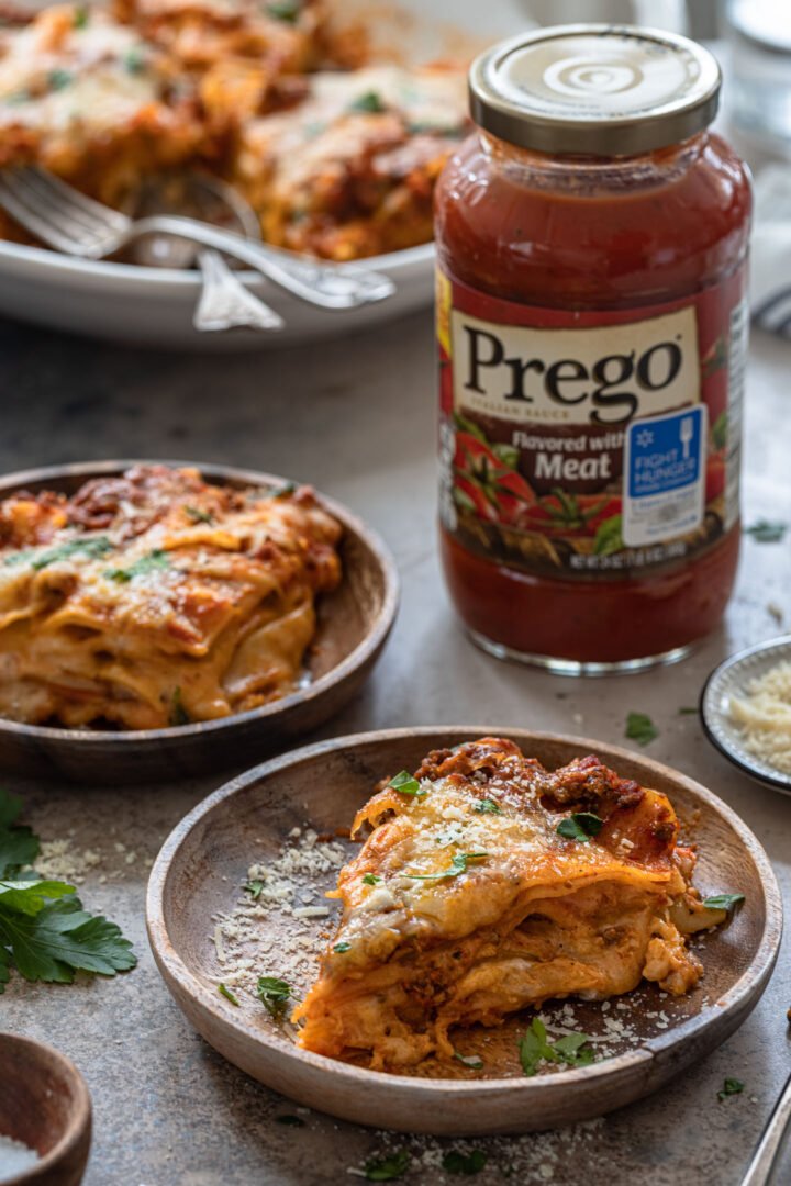 Two individual servings of pressure cooker lasagna and a jar of Prego sauce.