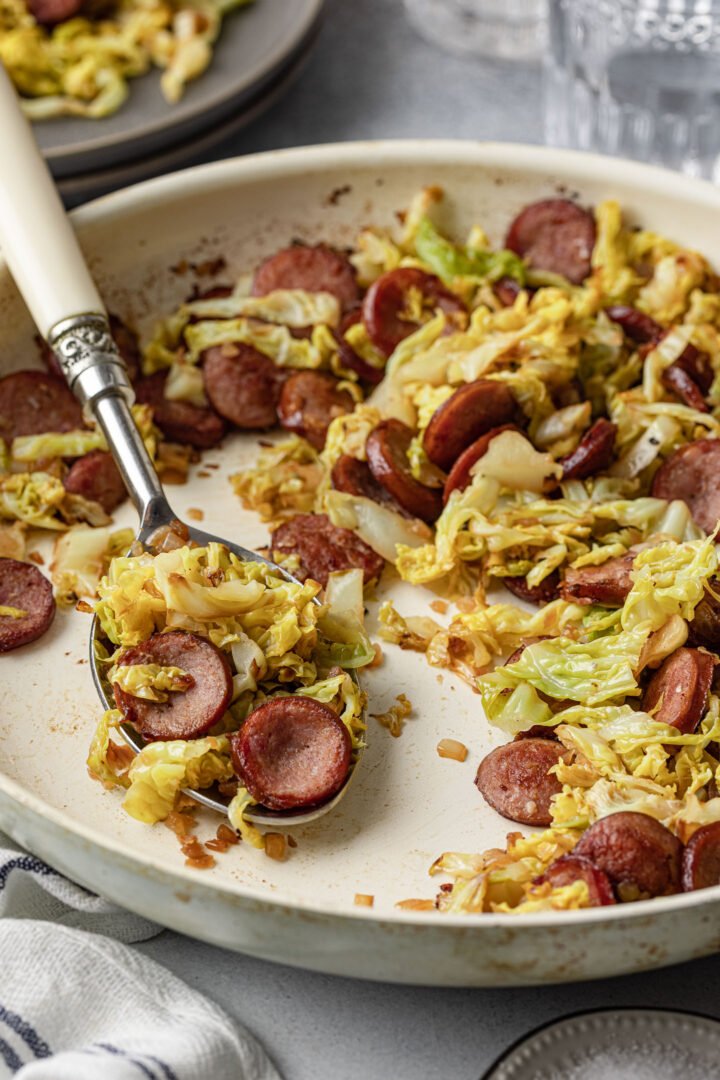 A close up shot of a pan with Sausage and Cabbage Skillet.