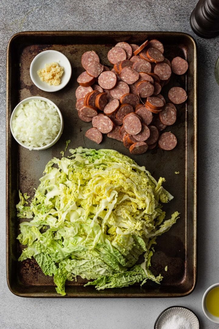 Shredded cabbage, sliced sausage, minced onion and garlic.