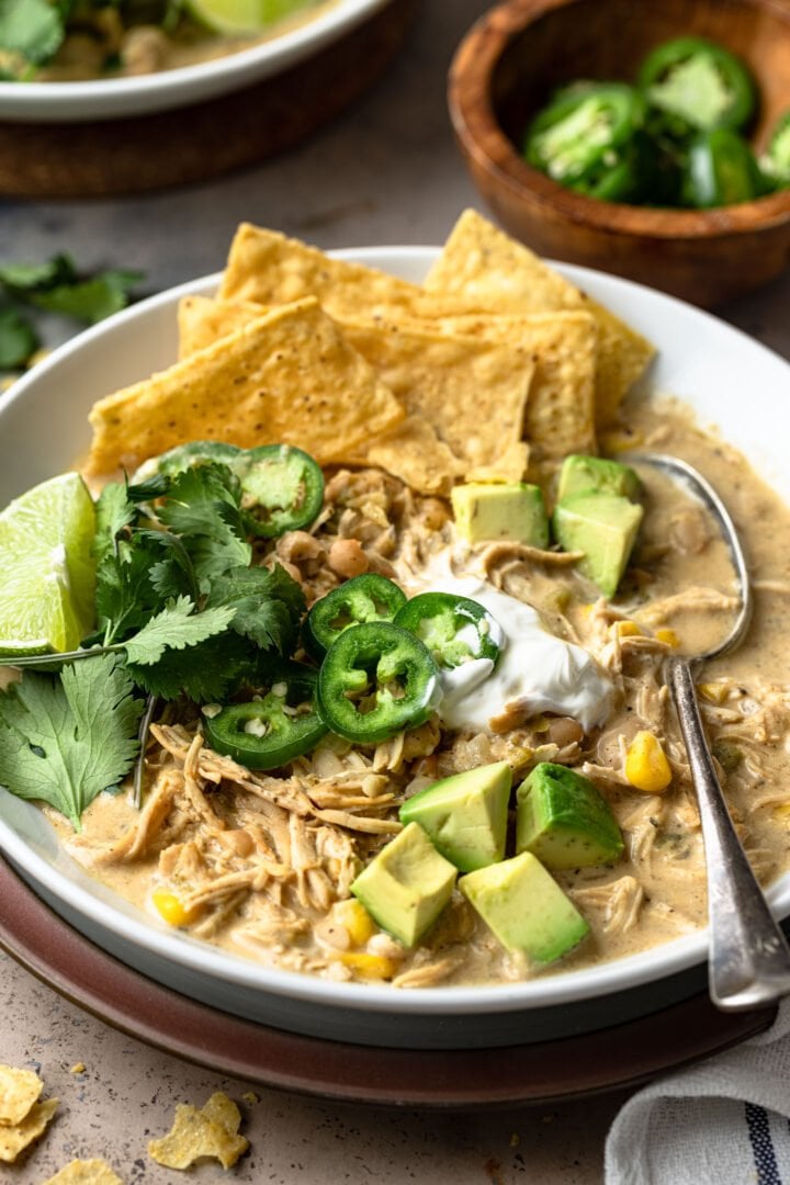 A close up photo of the white chicken chili with toppings.