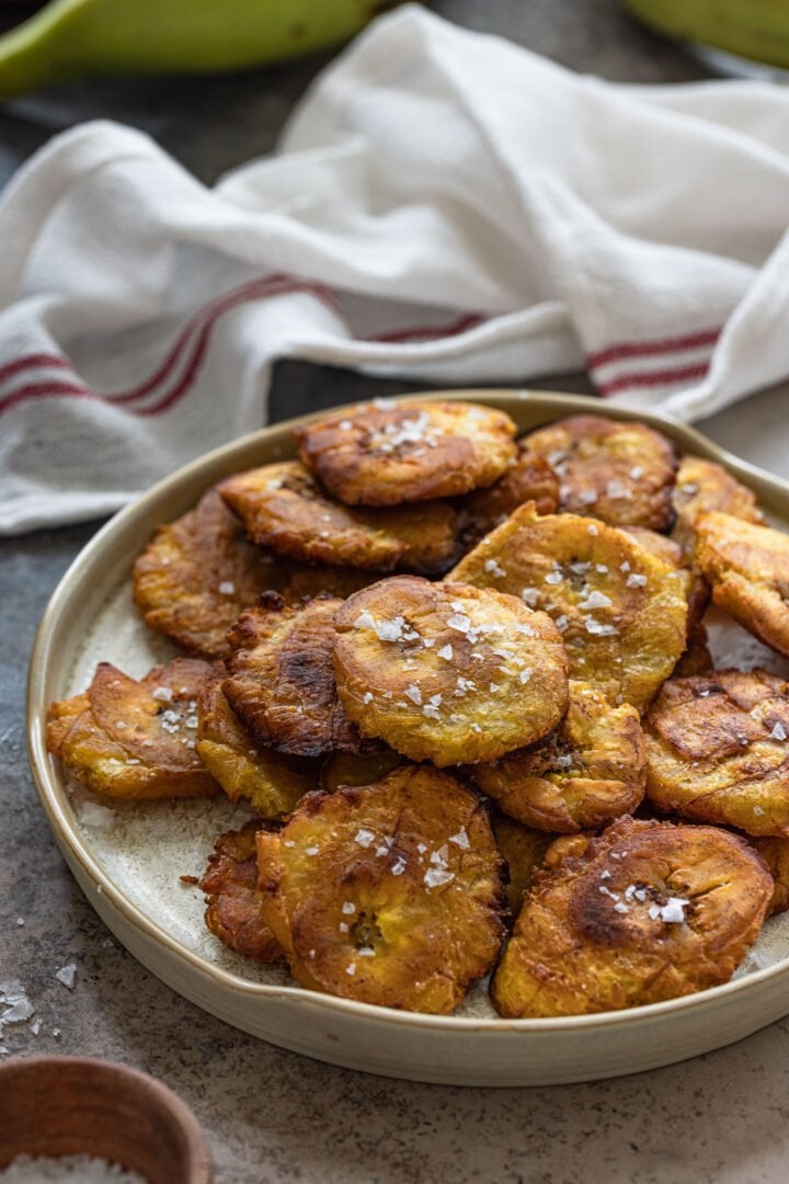 A platter of tostones sprinkled with flaky salt.