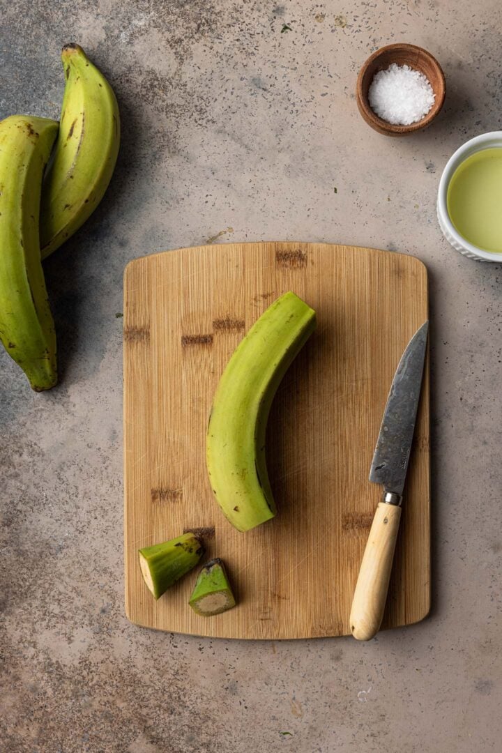 Cutting the edges of a plantain.
