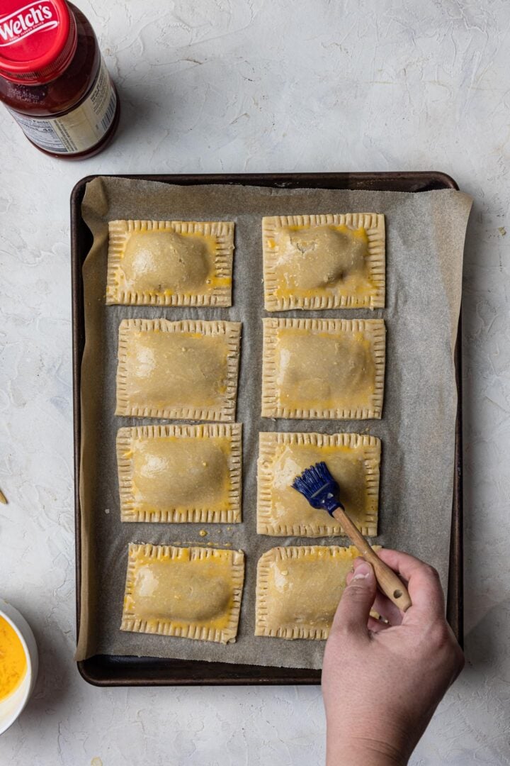 Brushing the toaster pastries with egg wash.