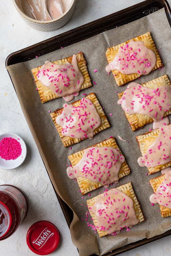 Toaster pastries frosted with strawberry icing and decorated with pink sprinkles.
