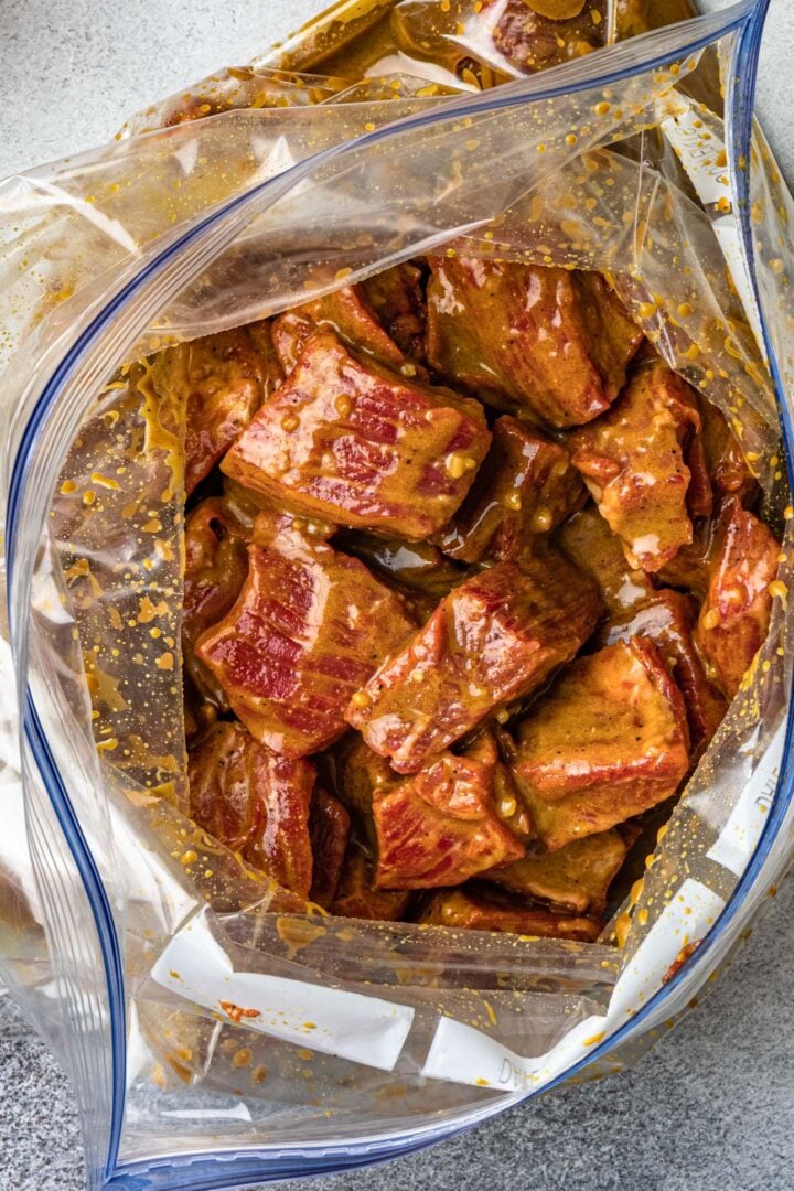 A bag of marinated flank steak chunks.