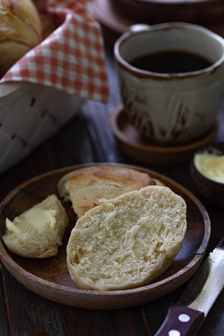 A pan frances split open to show the soft crumb.