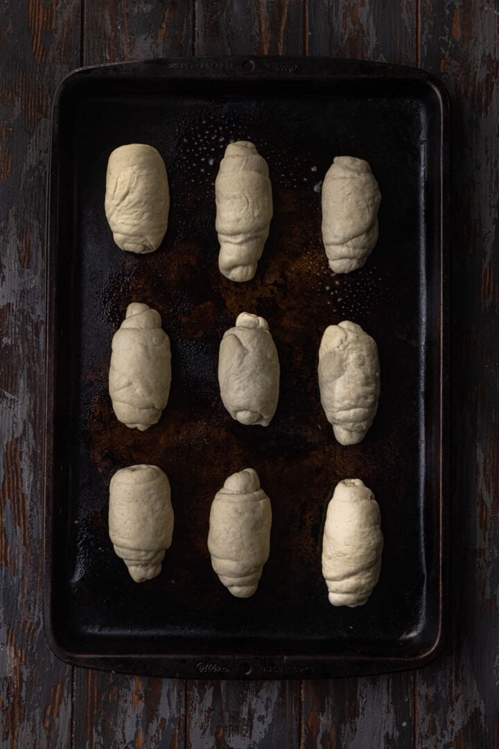 Rolls on a baking sheet, ready to be proofed.