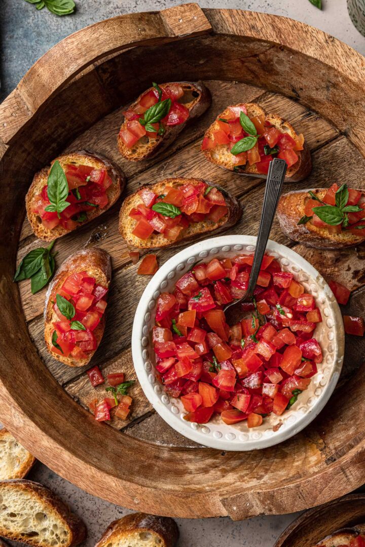 A close up overhead photo of a tray of tomato bruschetta.