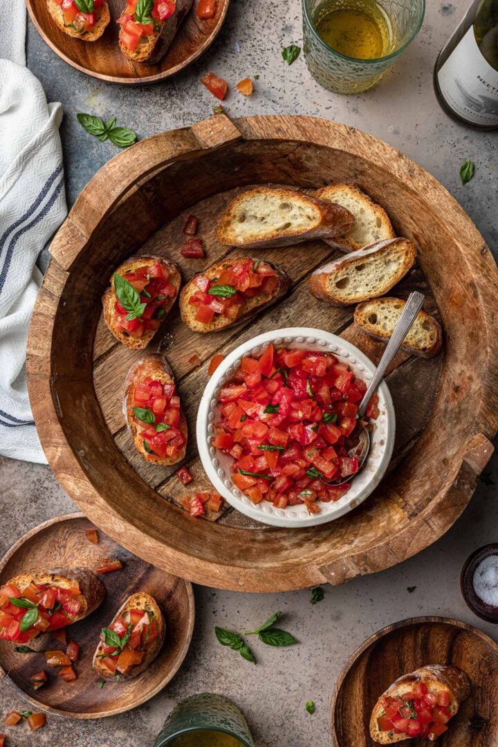 A wooden tray of tomato bruschetta.