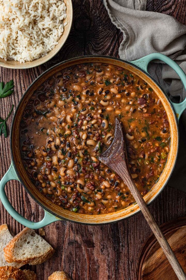 A pot full of black-eyed peas cooked with pork and herbs.