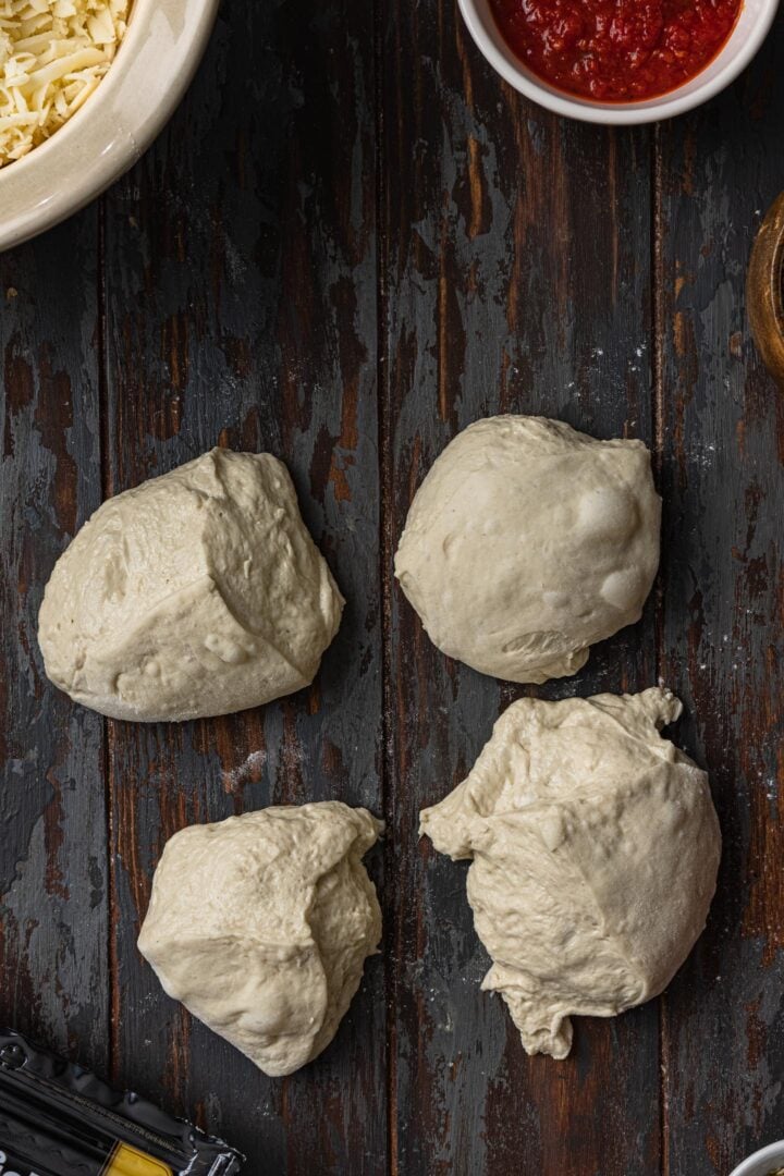 Pizza dough divided in 4 parts.