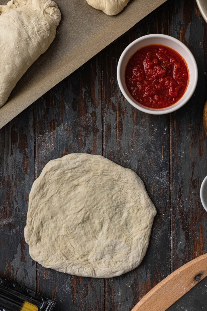 Pizza dough rolled into a circle.