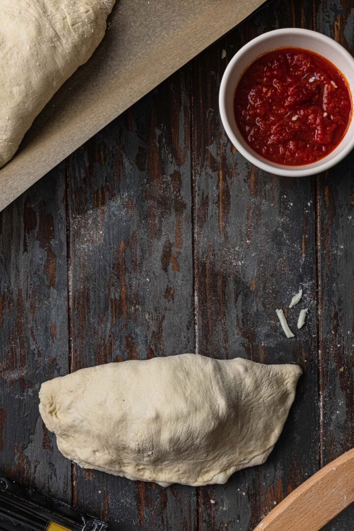 Close the calzone forming a half moon.
