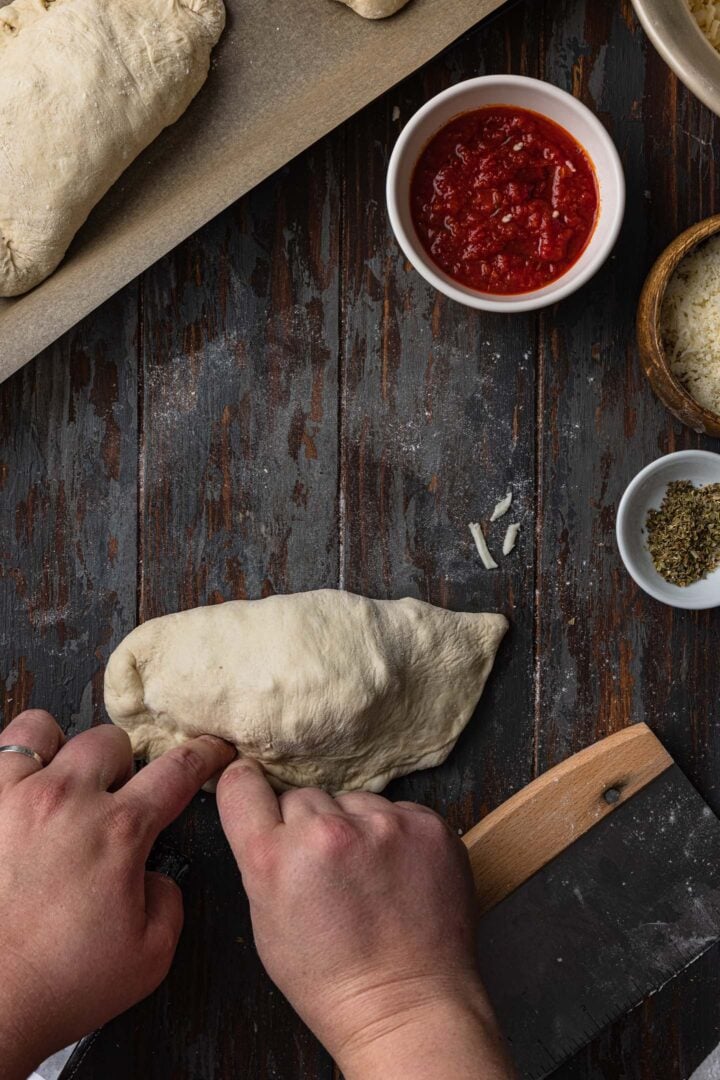 Crimping the edges of the calzone. 