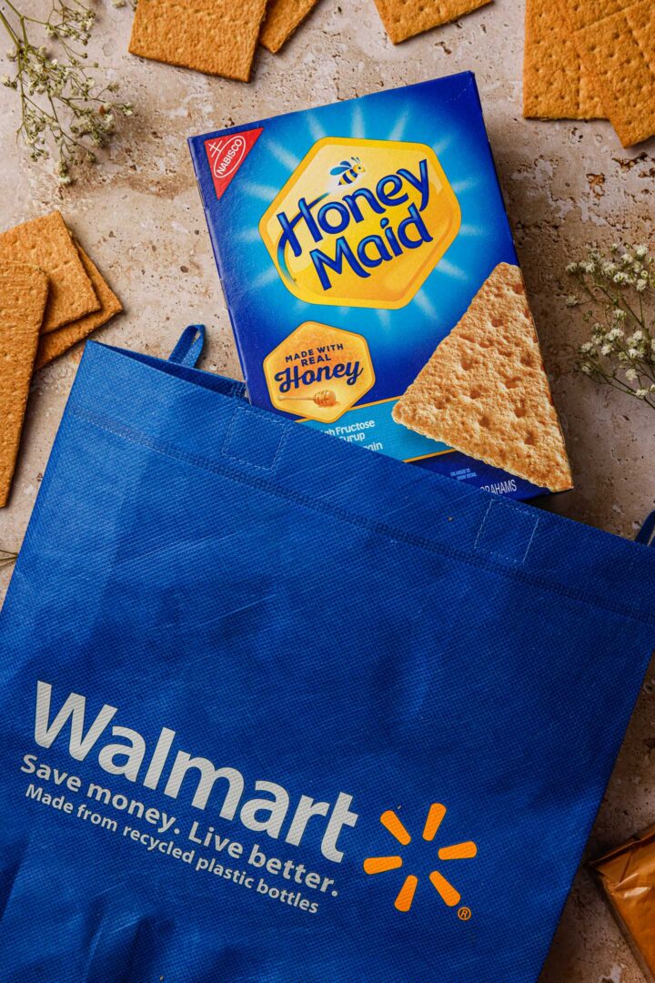 A Honey Maid graham cracker box coming out of a Walmart blue bag.