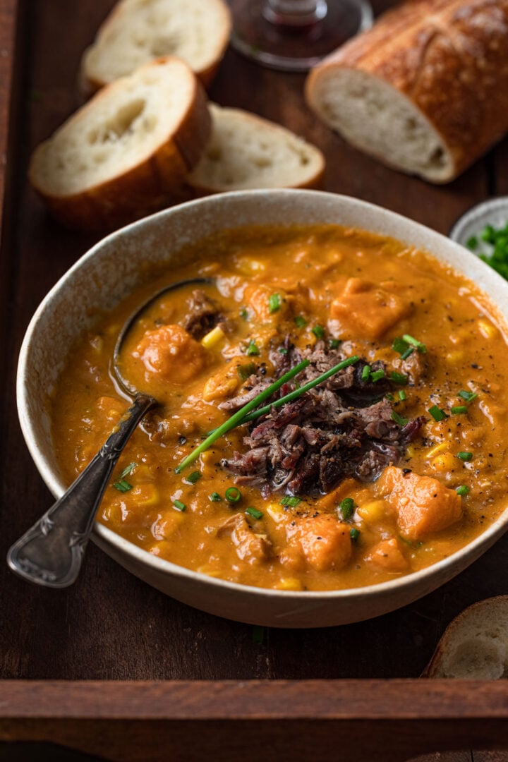 A close up shot of a bowl of sweet potato chowder soup.