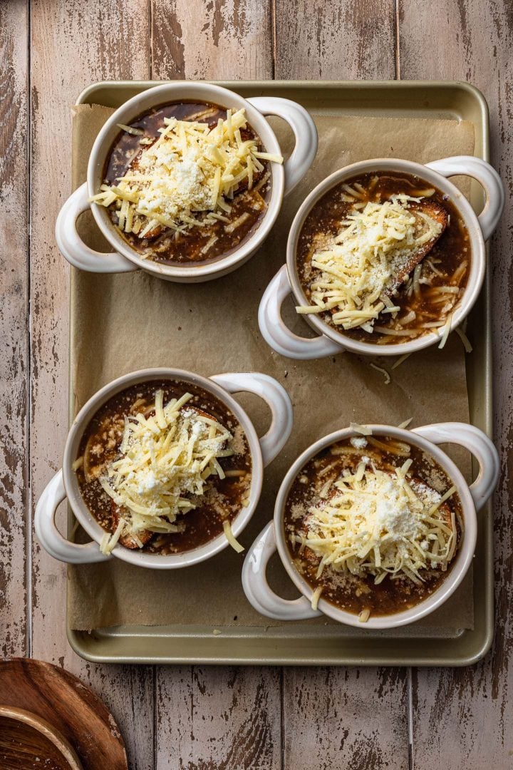 Soup bowls topped with the bread and cheese.