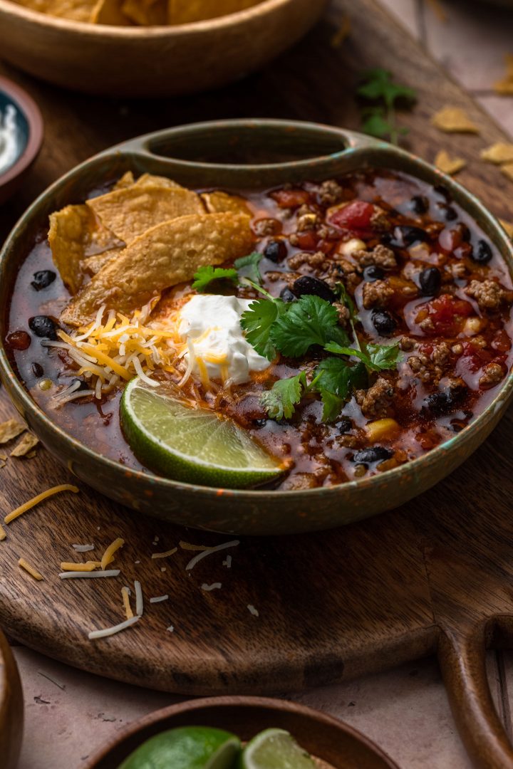 A close up photo of the taco soup recipe, with toppings.