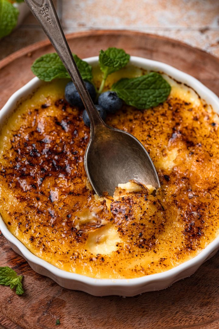 A spoon going through the brulee topping.