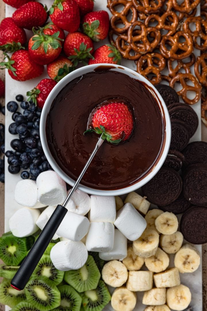 An overhead photo of a pot of chocolate and all the dippers.