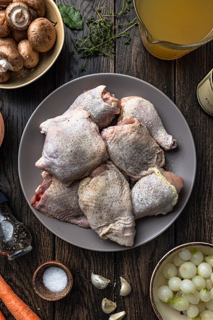 Chicken pieces seasoned with salt and pepper.