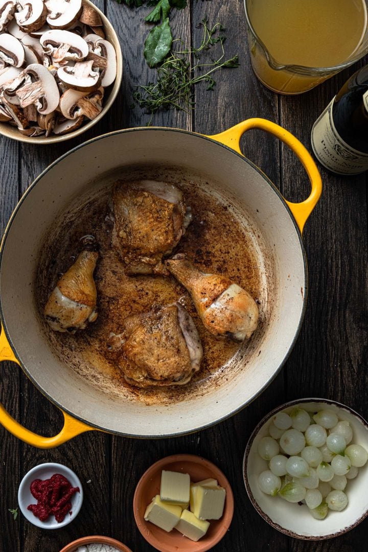 Browned chicken in a pot.