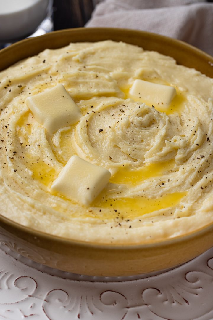 Close up of cheesy mashed potatoes. in a bowl.