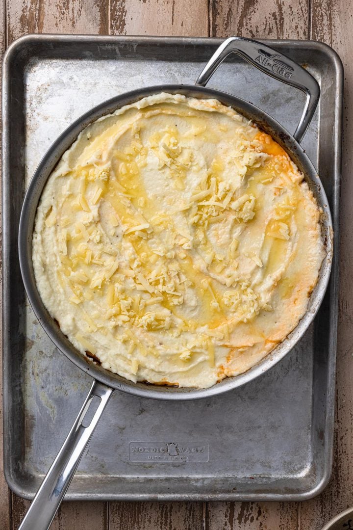 The shepherd's pie right before going into the oven: with drizzled melted butter and cheese.