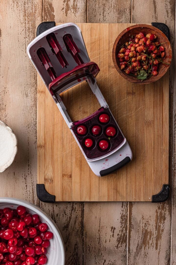 Pitting the sour cherries with a cherry pitter.