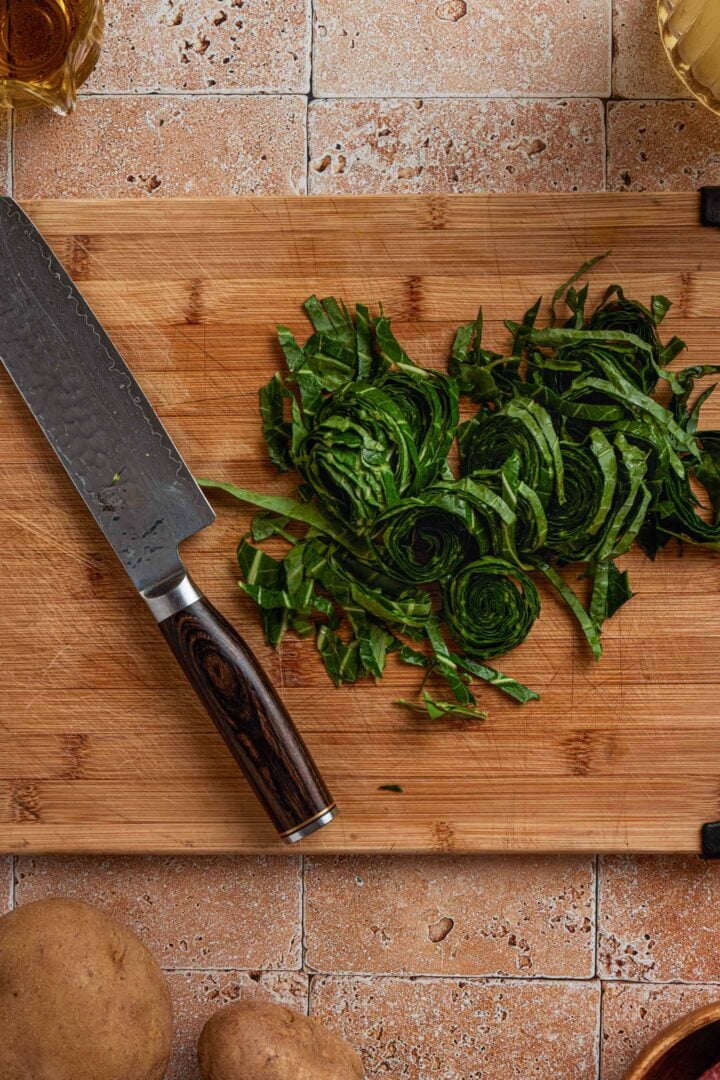 Cutting the collard greens into ribbons.