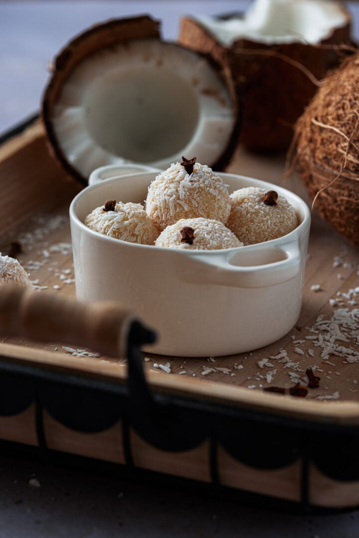 A few coconut truffles in a small container.