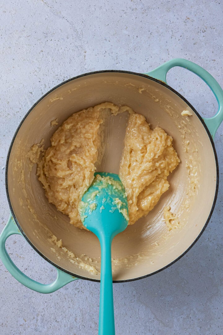 Showing the thickened mixture in a Dutch Oven, with a spatula running through the center.