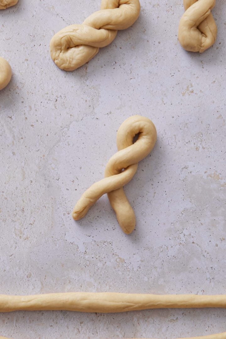 Close-up overhead photo of the dough twisted into a braided bun shape.