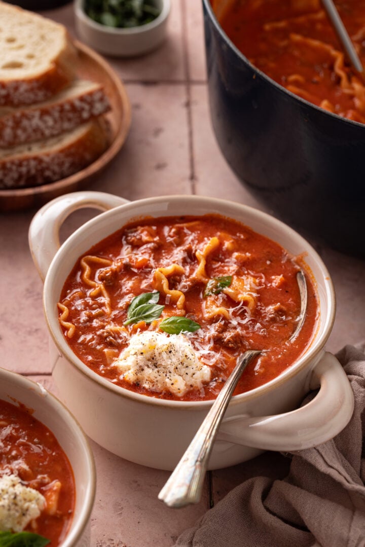 Creamy lasagna soup with ricotta, Parmesan, and fresh basil served in a bowl