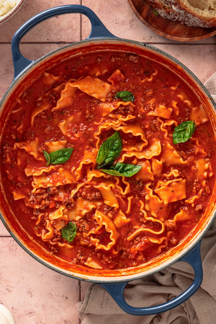 Close-up of lasagna soup in pot showing noodles, meat, and rich tomato broth
