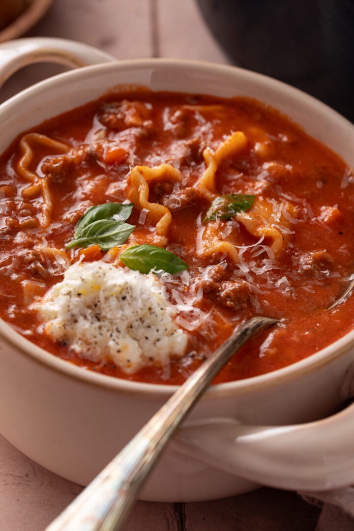 Close-up of lasagna soup in pot showing noodles, meat, and rich tomato broth