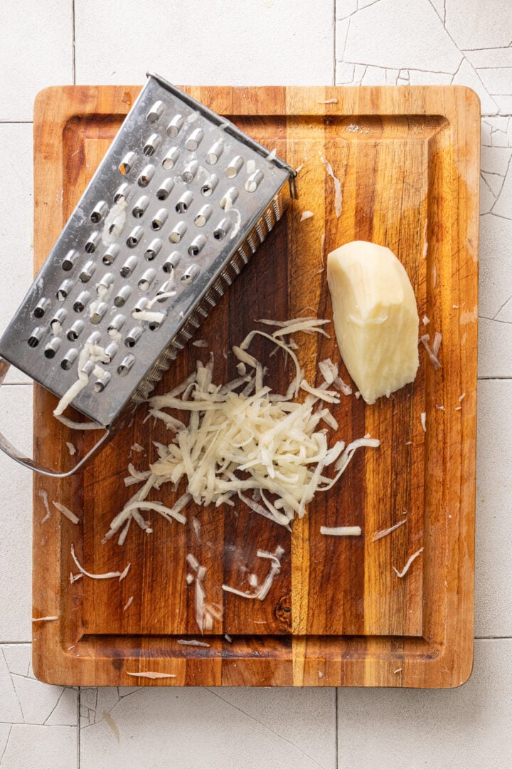 Box grater used as an alternative way to shred potatoes for batata palha.