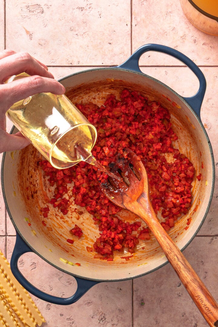White wine deglazing pot and lifting browned bits